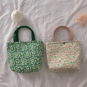 Detail of floral canvas lunch bags with metal snap buttons and thick insulated lining