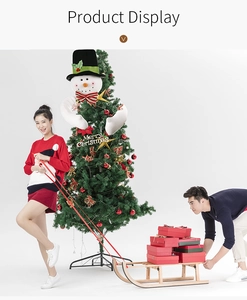 Detail of plush snowman tree topper with long bendable arms and red striped bow