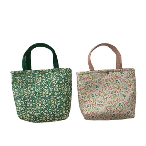 Floral insulated lunch bags in green and beige patterns with metal snap closures