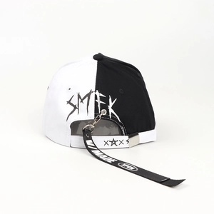 Detail of SMFK gothic font printing on black and white contrast baseball cap with streamers