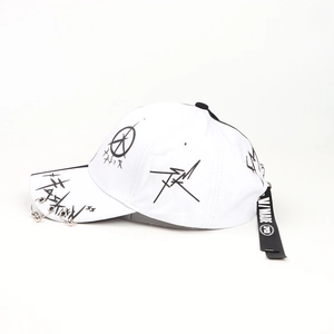 Close-up of white graffiti baseball cap with metal rings and black logo strap detail