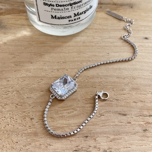 925 silver bracelet with large square zircon stone on an elegant wooden background