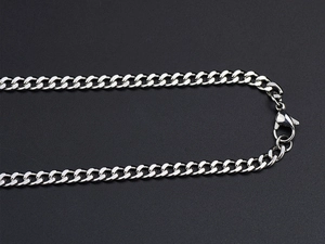 Macro shot of silver titanium steel Cuban link chain with a secure lobster clasp