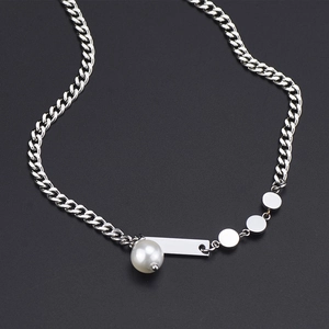 Silver cuban chain necklace with pearl and metal pendants on black background