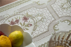 Detail of chenille table runner featuring intricate floral jacquard and tassel texture