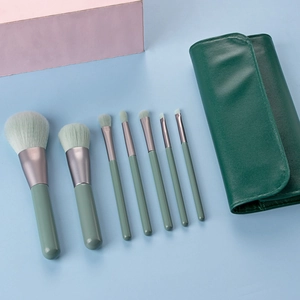 Detail of 7-piece mini makeup brush set in Morandi green with dark green leather pouch