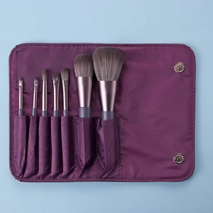 Detail of 7-piece purple travel makeup brush set in a roll-up magnetic closure pouch
