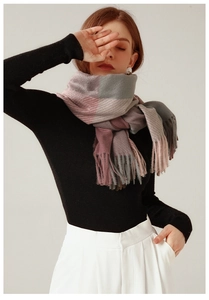 Detail shot of pink and grey checkered winter scarf with elegant fringe tassels