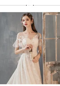 Detail of delicate lace flower embroidery on the sheer mesh neckline of this French bridal gown