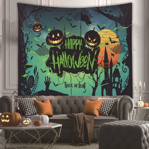 Halloween tapestry detail with pumpkins and castle hanging over a leather sofa