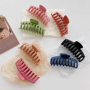 Detailed view of matte large hair claws in six colors with a multi-tooth grip design
