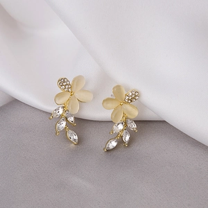 Detailed view of tulip cat-eye stone earrings with gold base and sparkling cubic zirconia