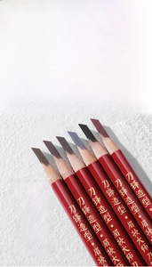 Macro detail of multi-colored flat-tip eyebrow pencils with red lacquered barrels