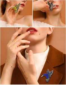 Exquisite hummingbird brooches with colorful rhinestones on a stylish wool coat