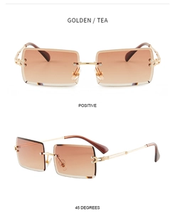 Close-up of golden rimless rectangle sunglasses with tea gradient lenses and metal arms