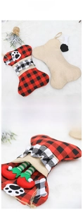 Detail of bone-shaped burlap Christmas stocking featuring elf legs and plaid ruffles decoration