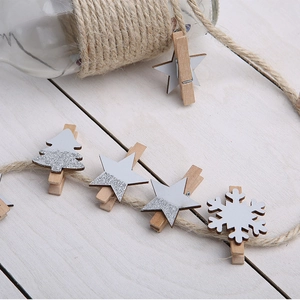 Wooden Christmas clips set with silver glitter stars and trees on natural jute rope