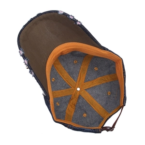 Detail of denim baseball cap interior featuring durable stitching and adjustable metal buckle