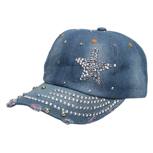 Detail of blue washed denim baseball cap with star rhinestones and gold studs