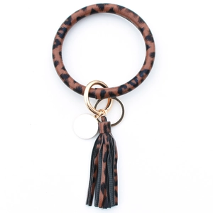 Detailed view of leopard print PU leather wristlet keychain with tassel and gold ring