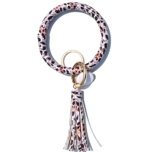 Detail view of pink leopard print PU leather wristlet with golden keyring and tassel