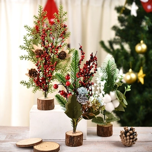 Miniature Christmas trees with pine cones and berries on wooden bases for table decor
