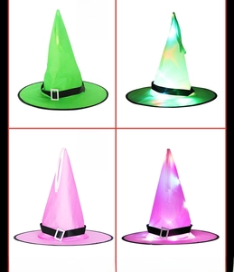 Detail of LED glowing Halloween witch hats in green and pink colors with buckle