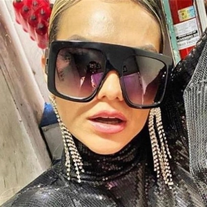 Oversized retro square sunglasses with thick black frames and dark gradient lenses
