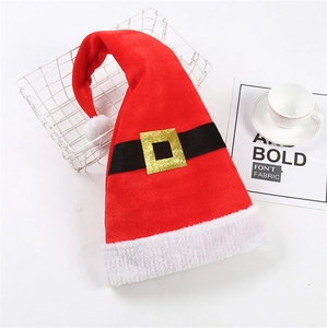 Detail of red velvet elf hat with black belt, gold buckle, and soft white faux fur trim