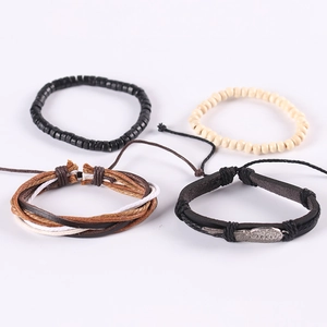 Detailed view of 4-piece leather and wood bead bracelet set with feather wing charm