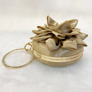 Detail of champagne gold silk flower evening bag with rhinestone ring handle