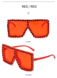 Detailed views of red oversized square sunglasses with hand-set rhinestones from two angles