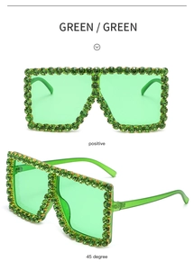 Close-up of green oversized sunglasses with sparkling crystal rhinestones and flat lenses