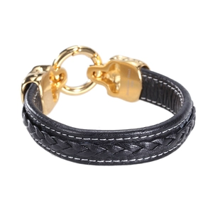 Men's black woven leather bracelet with a polished gold stainless steel skull clasp