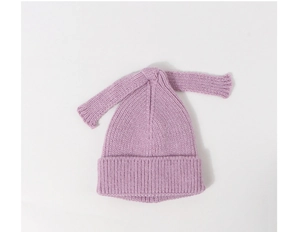 Detail showing high-quality purple rib-knit texture and long decorative ties on baby hat
