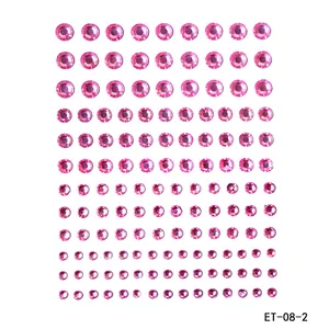 Detailed close-up of pink self-adhesive acrylic rhinestone stickers for DIY body art