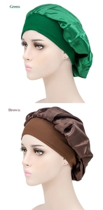 Detail of wide elastic band on green and brown satin sleep caps for long hair