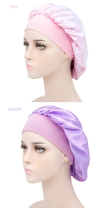 Detail of pink and light purple satin sleep caps featuring wide elastic comfort bands