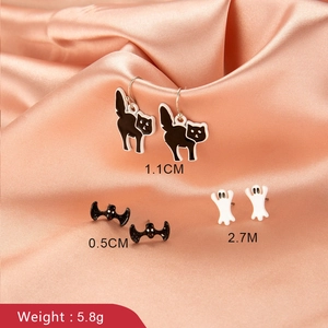 Halloween jewelry set with black cat bat and white ghost studs on pink silk background