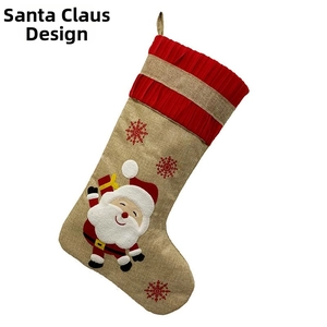 Detail of linen Christmas stocking featuring 3D Santa Claus and red snowflake embroidery