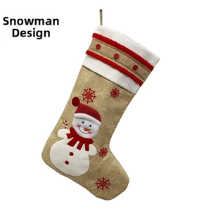 Detail showing embroidered snowman on burlap Christmas stocking with white fleece cuff