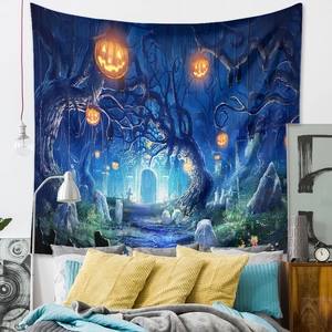 Detail of Halloween tapestry with glowing pumpkins and forest hung over a cozy bedroom bed