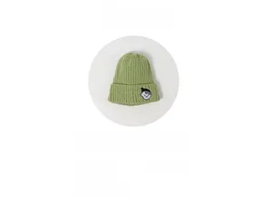 Detail of green knitted beanie featuring a cartoon face embroidery and fold-over cuff