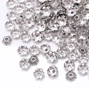 Macro shot of antique silver flower bead caps and alloy spacers for DIY jewelry making