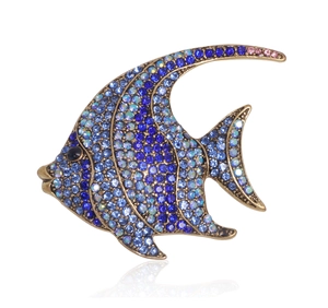Detailed macro of a crystal fish brooch with blue rhinestones and gold alloy plating