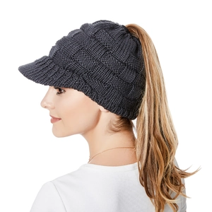 Detail of dark grey knit ponytail beanie with sun visor and textured cable stitch