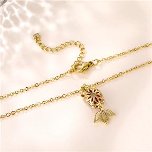 Golden titanium steel necklace featuring a hollow pendant with a bright red gemstone