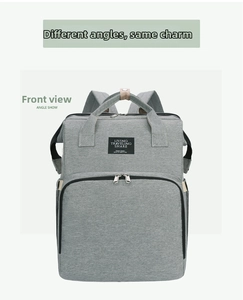Front view of grey multipurpose diaper backpack with large zipper pocket and top handles