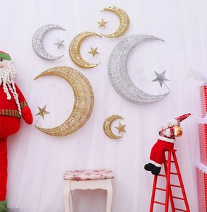Detail of metal star and moon ornaments in gold and silver for Christmas decor