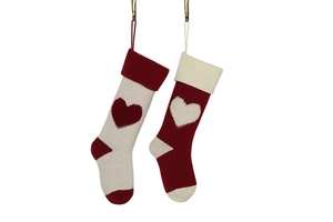 Detailed knit texture of red and white Christmas stockings with plush 3D heart pattern